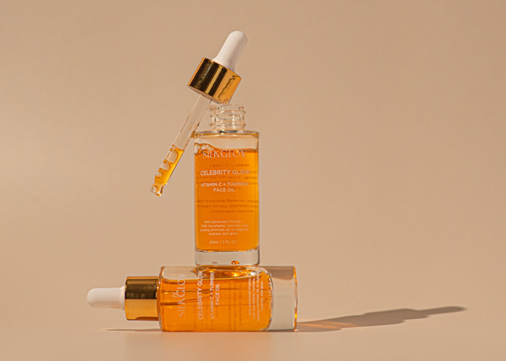 Minimal styled product photography set up for two skincare oil bottle